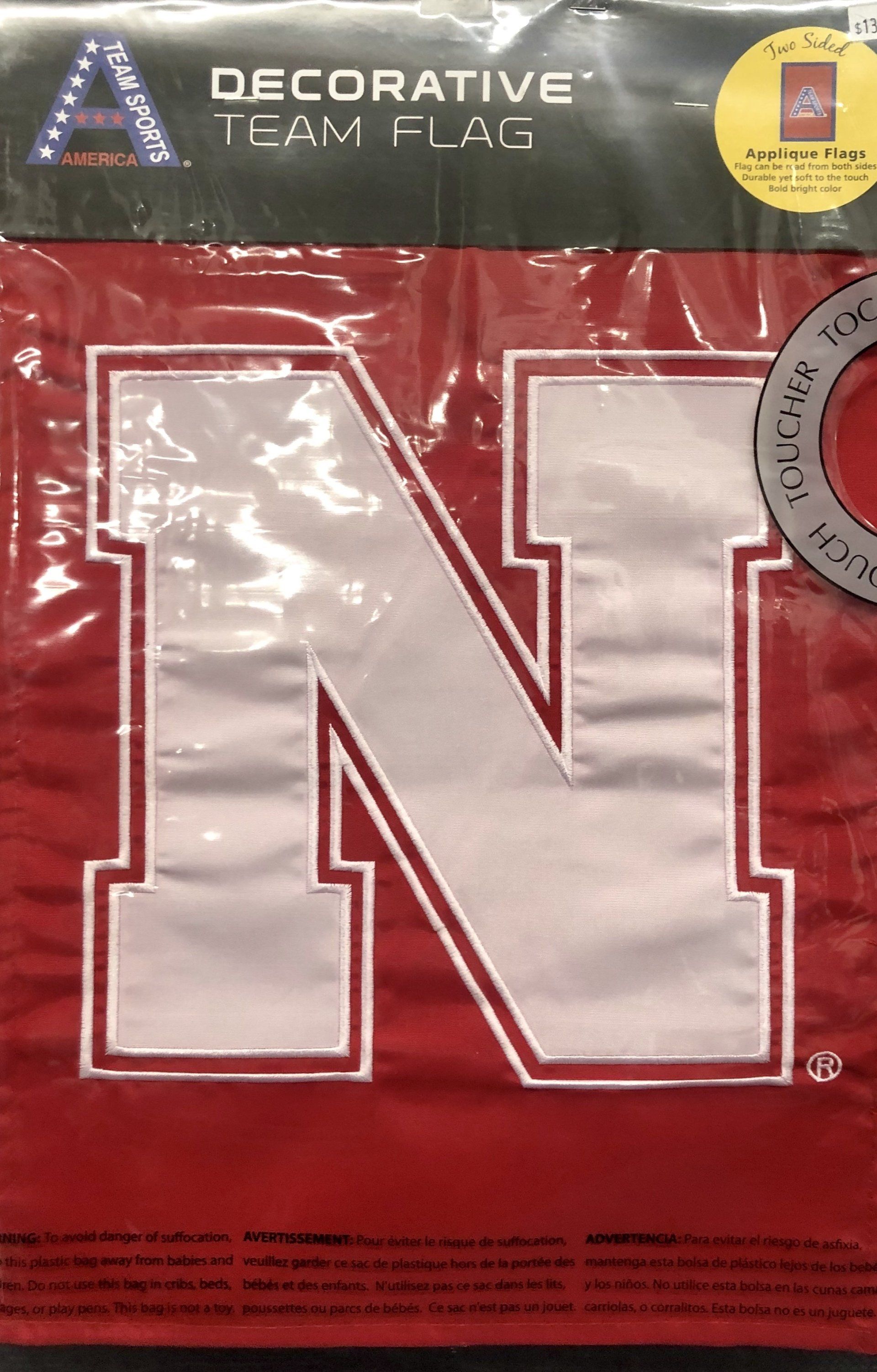 A decorative red flag featuring a large white collegiate-style letter 