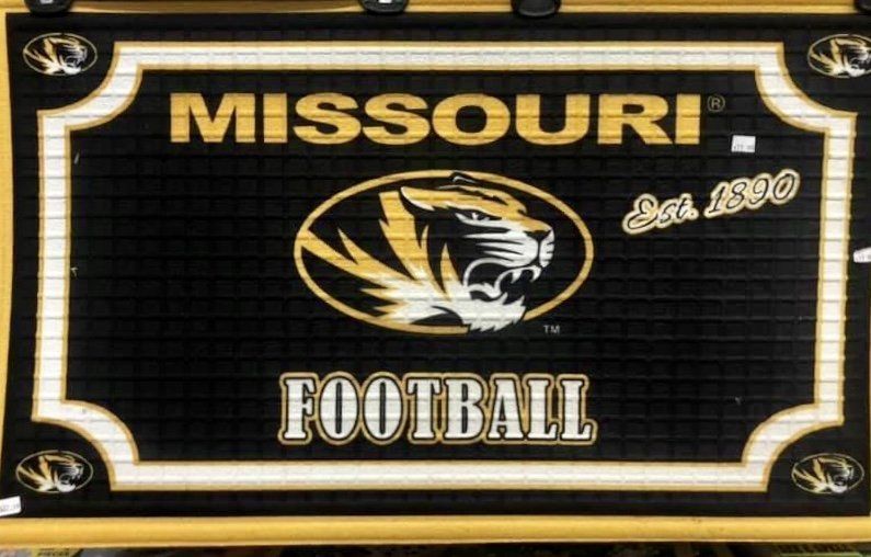 Black and gold Missouri Tigers football rug featuring the team logo, the word 