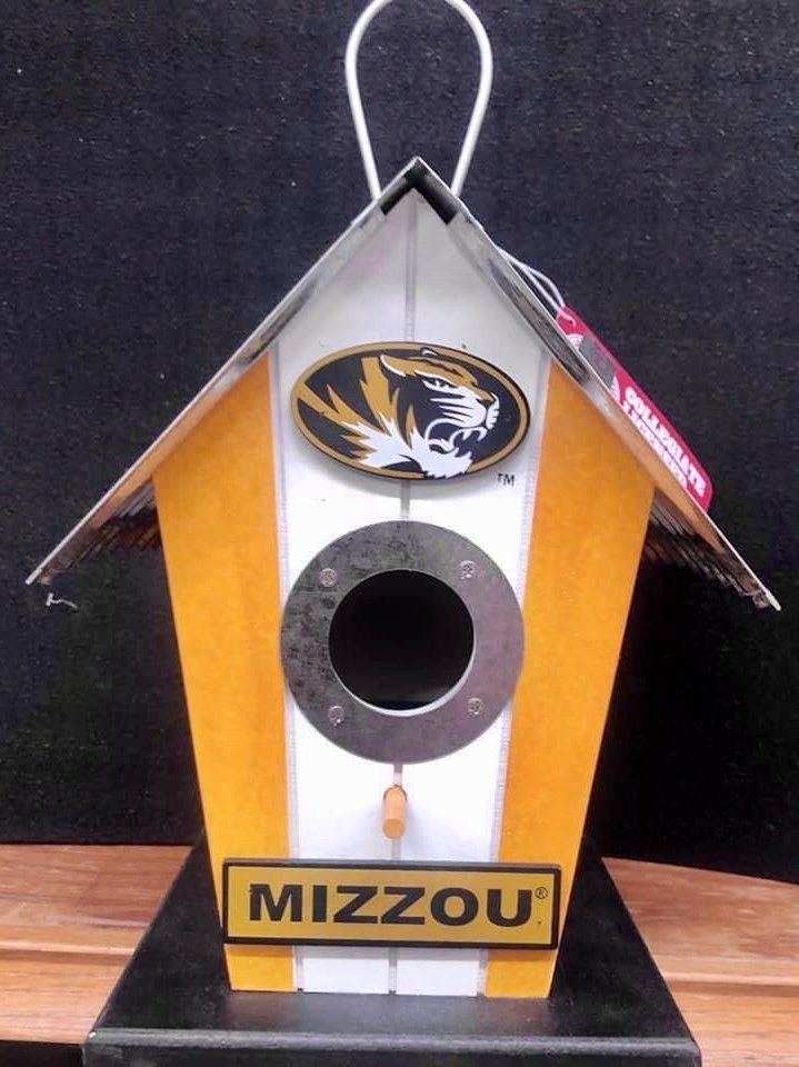 A Mizzou-themed birdhouse with a black and gold tiger logo, a round entrance hole, and a metal roof.