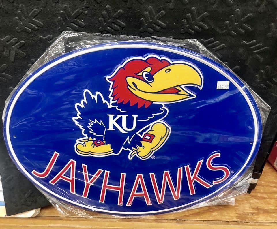 Oval sign featuring the blue Kansas Jayhawk mascot, the letters 