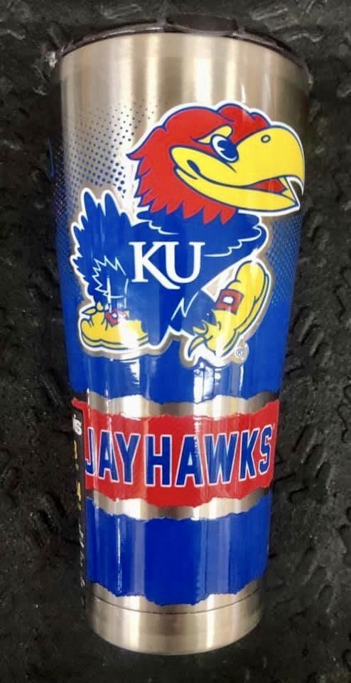 A stainless steel tumbler featuring the University of Kansas Jayhawk mascot, the letters 