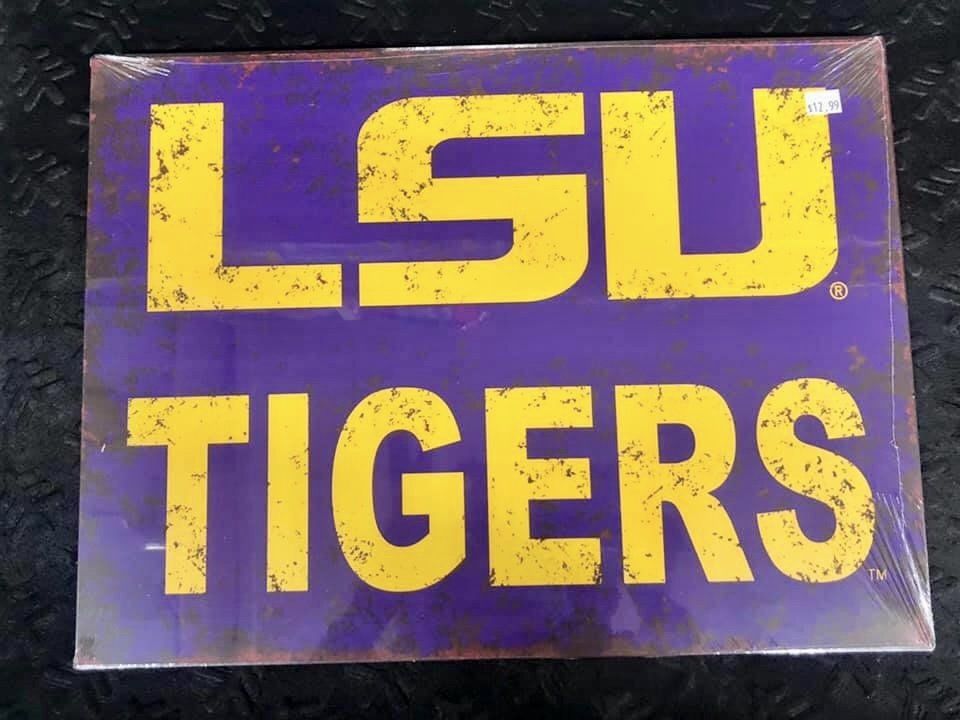 A purple rectangular sign with the yellow text 