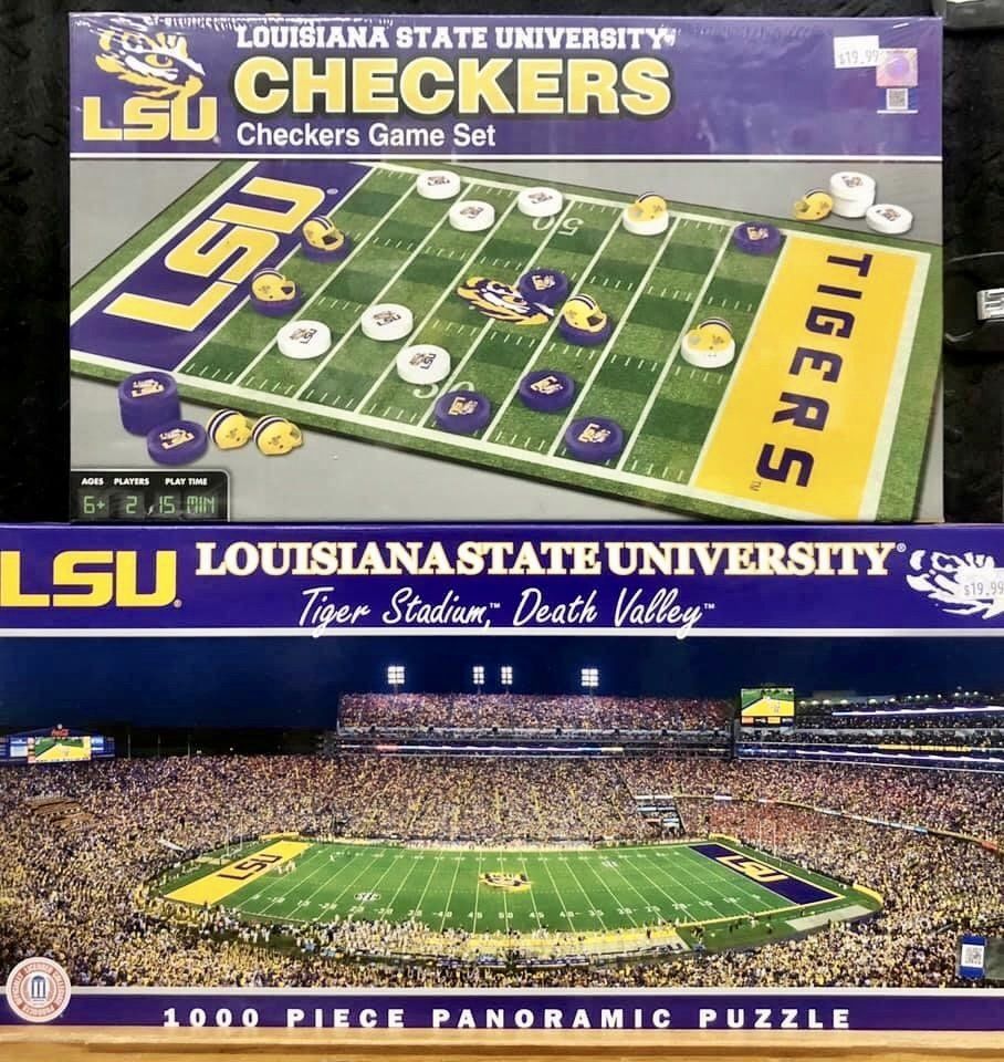A top box for an LSU checkers set featuring a football field board, stacked above a box for an LSU stadium jigsaw puzzle.