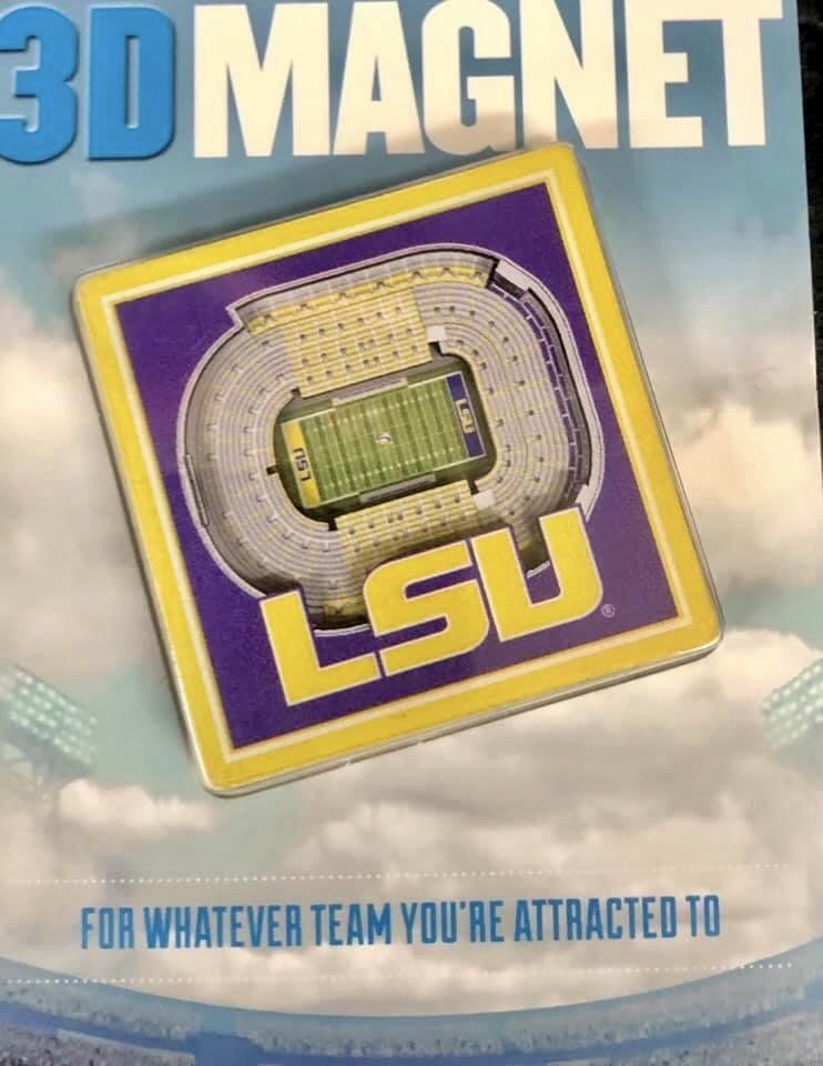 A square LSU 3D magnet depicting the stadium on a purple background with yellow text, set against a cloudy sky backdrop.
