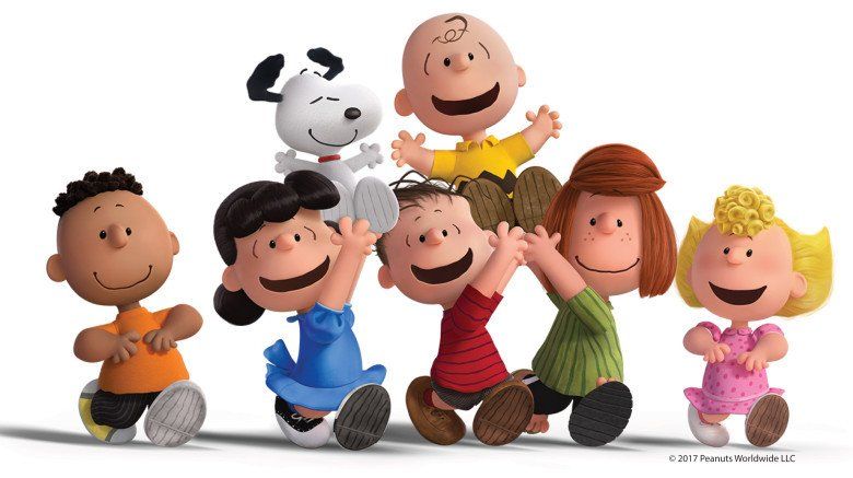 Charlie Brown, Snoopy, and friends smiling and dancing together in a cheerful group portrait against a white background.