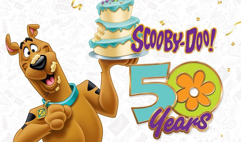 Scooby-Doo holding a bitten tiered cake next to a 