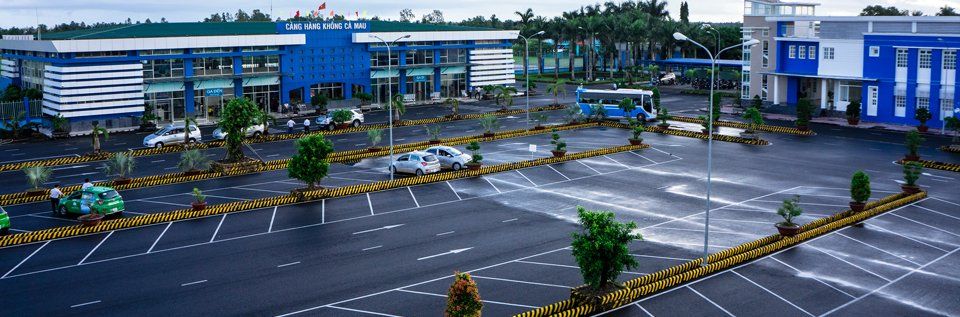 An aerial view of a parking lot with a building in the background