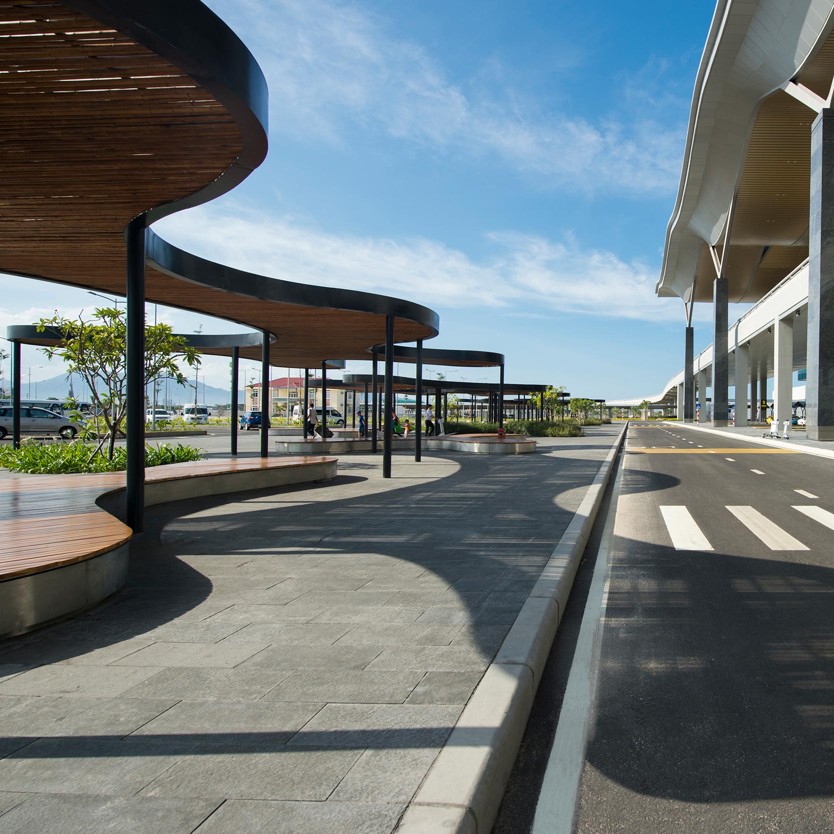 A concrete walkway with a bridge in the background