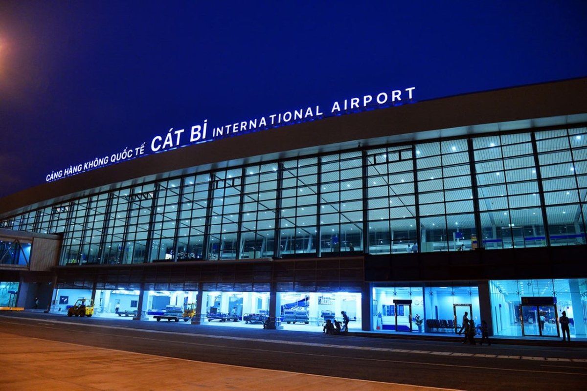A large building with a lot of windows is lit up at night.