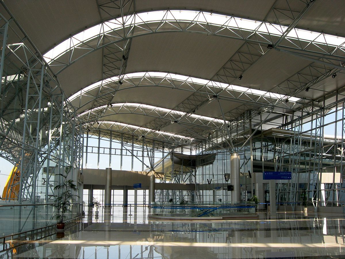 A large building with a lot of windows and a curved roof