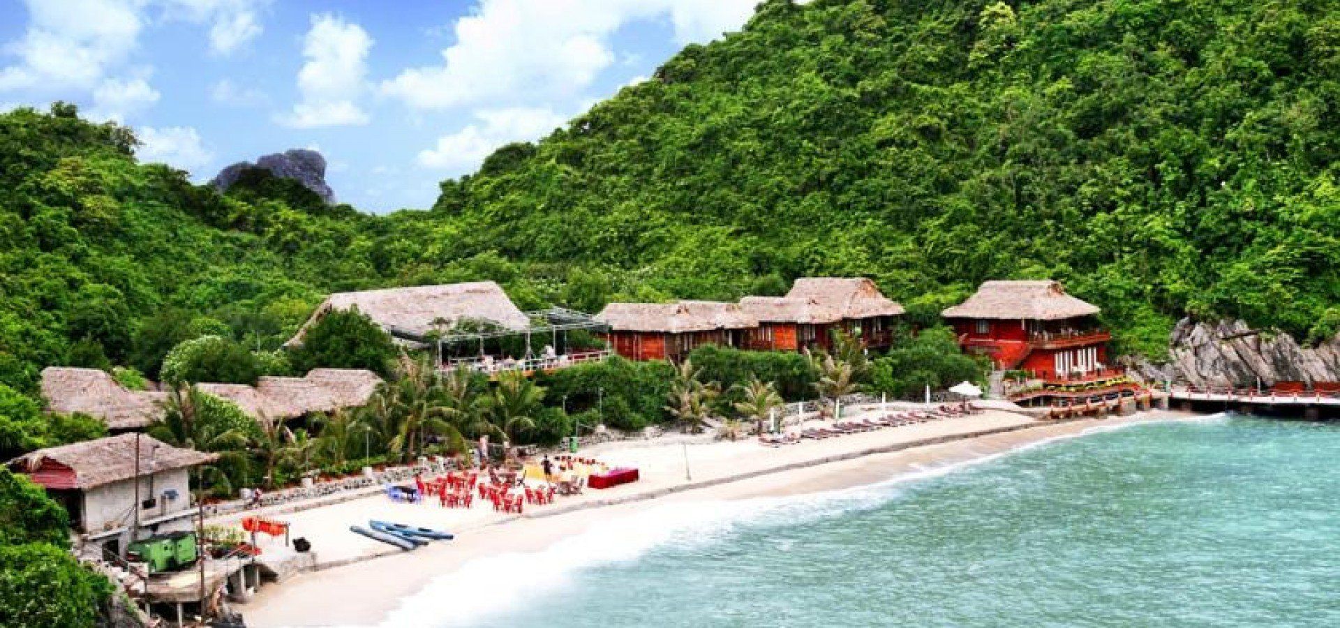 A tropical beach with a lot of buildings on it