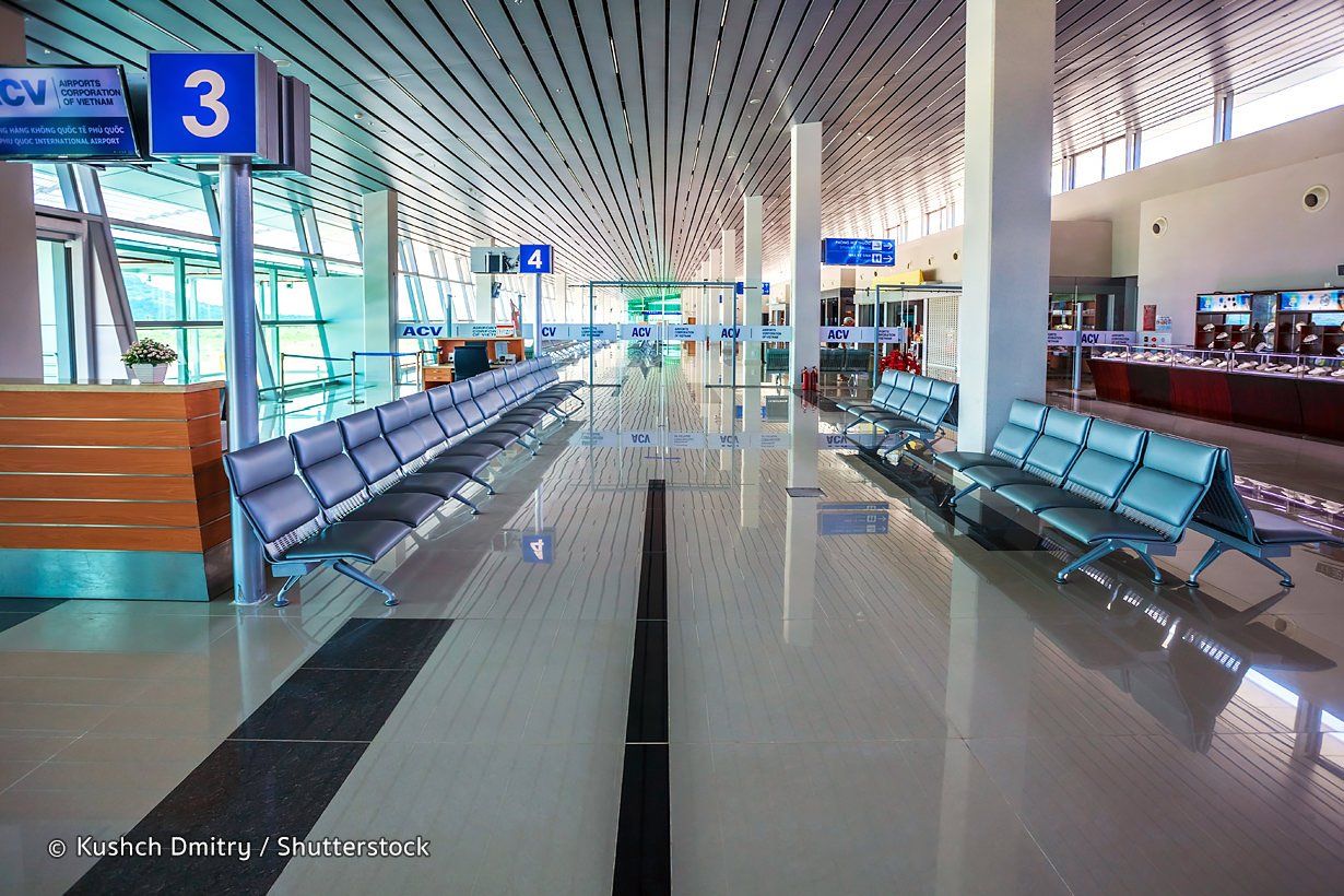 A waiting area at an airport with a sign that says 3