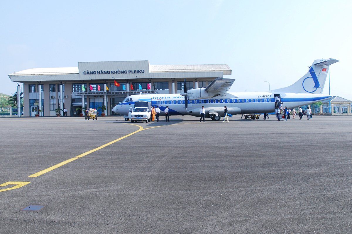 A plane with the letter s on the tail is parked at an airport