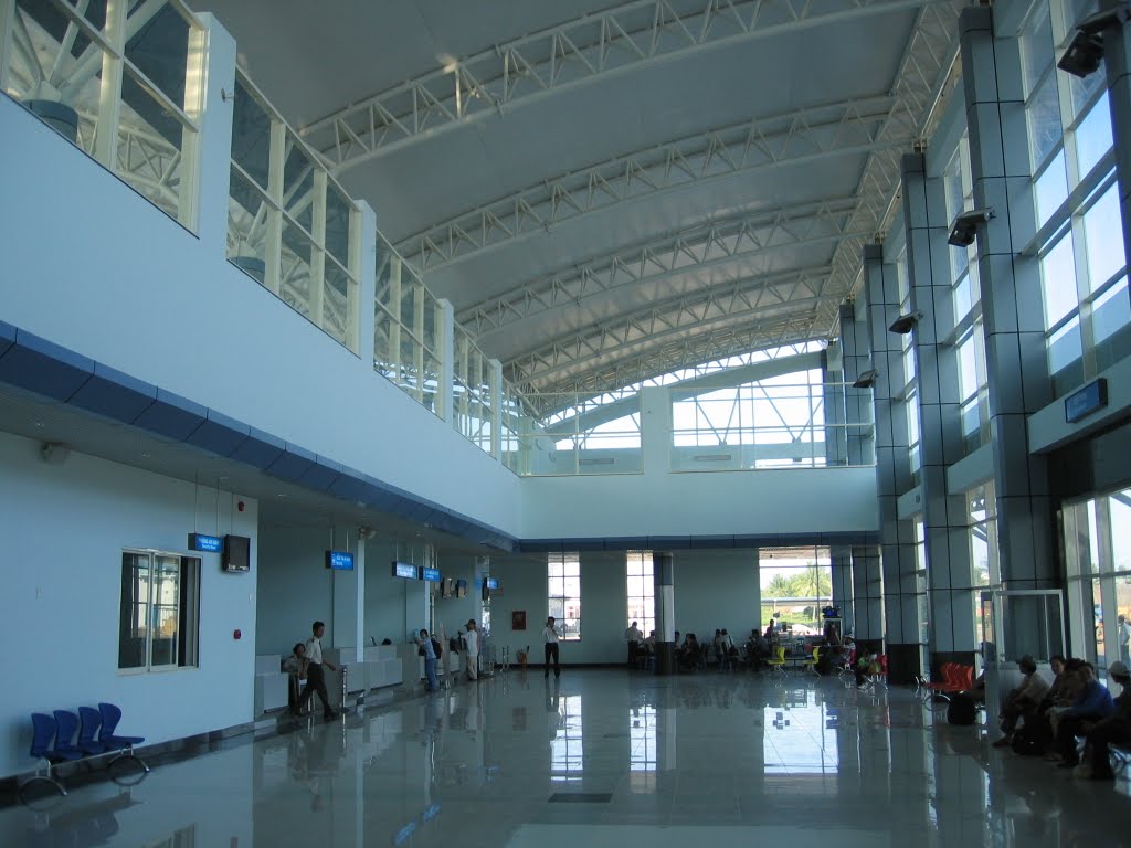 A large room with a lot of windows and people sitting in it