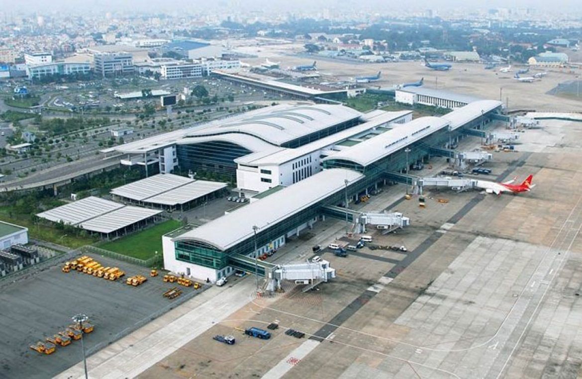 An aerial view of an airport with planes parked on the tarmac.