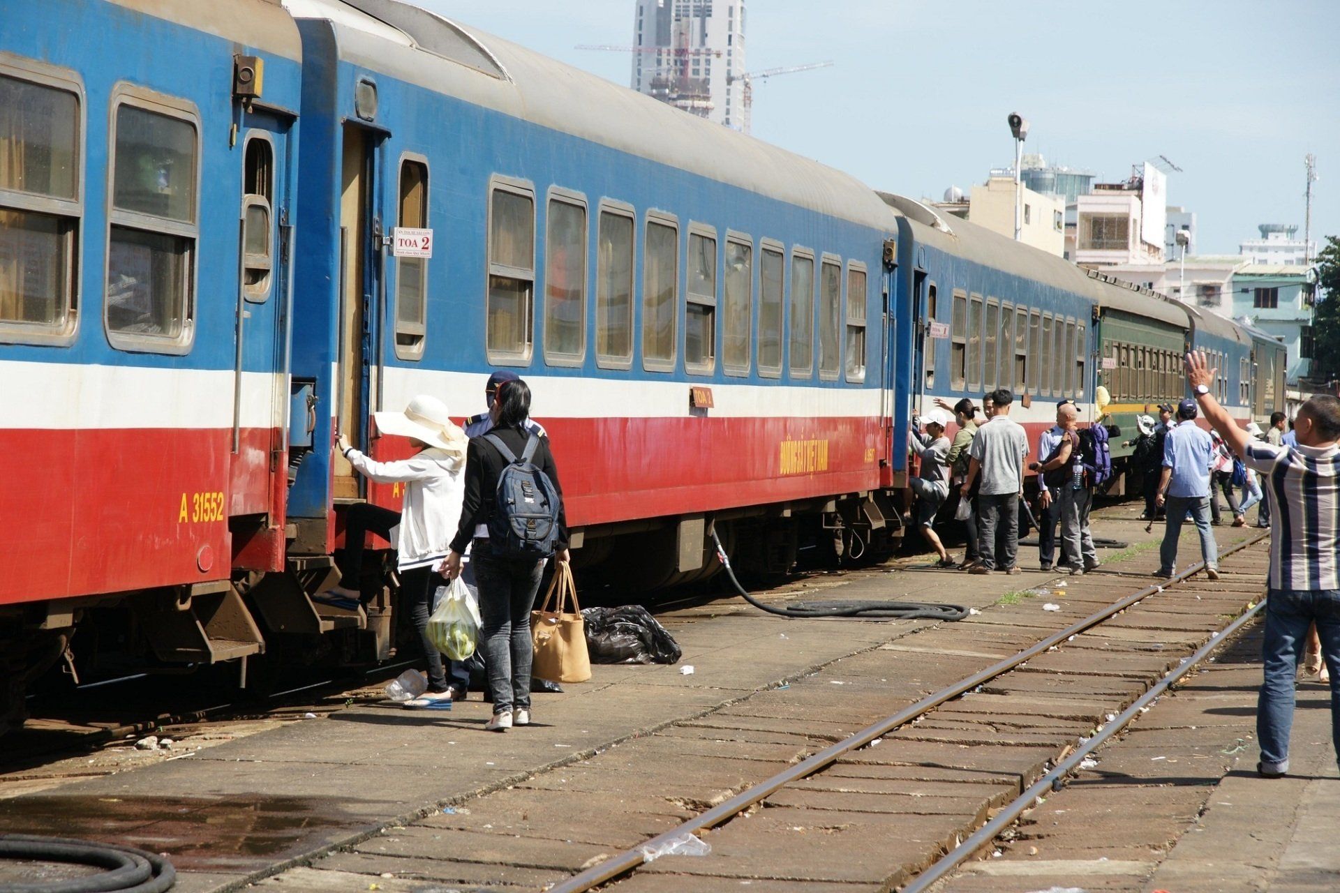 A group of people are boarding a train at a train station.