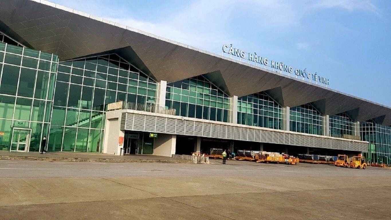 A large building with a lot of windows and planes parked in front of it.