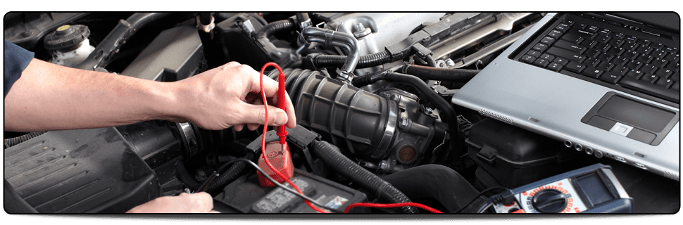 For the installation and repair of electronic systems in motor vehicles in Manchester, call G.S.A. Auto Electrics Close-up view of hand holding a testing device on a vehicle