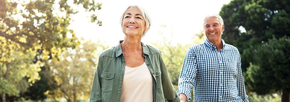 Dental Implants - older male and female smiling.