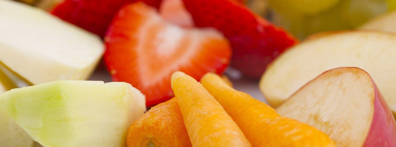 A close up of a plate of fruit and vegetables.