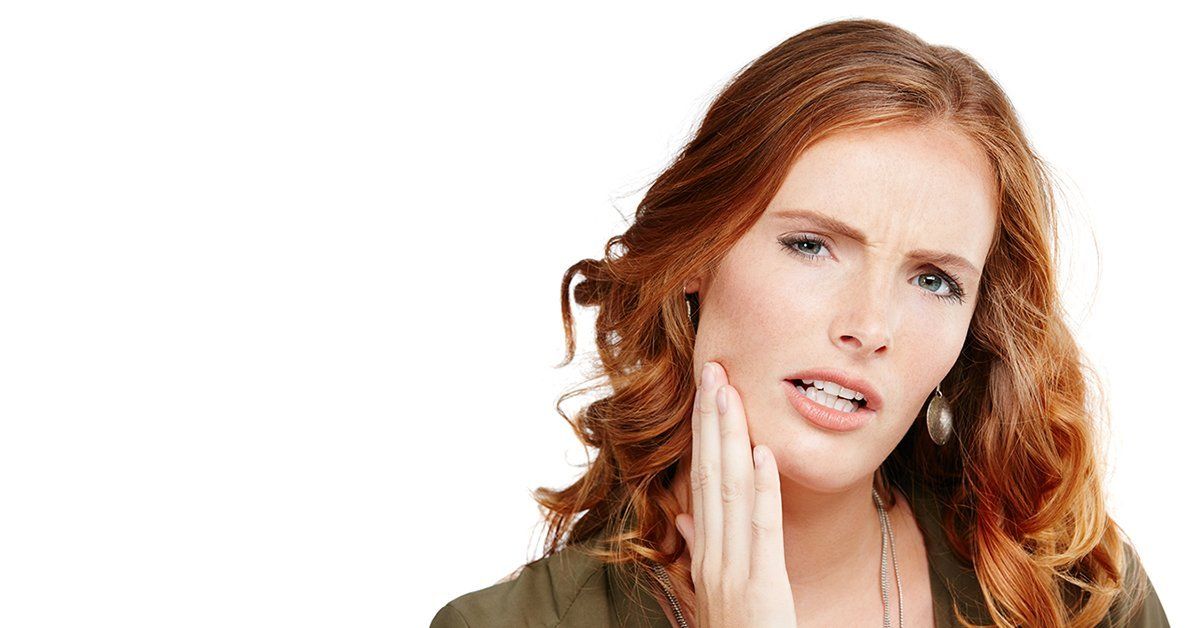 Redhead woman having tooth pain