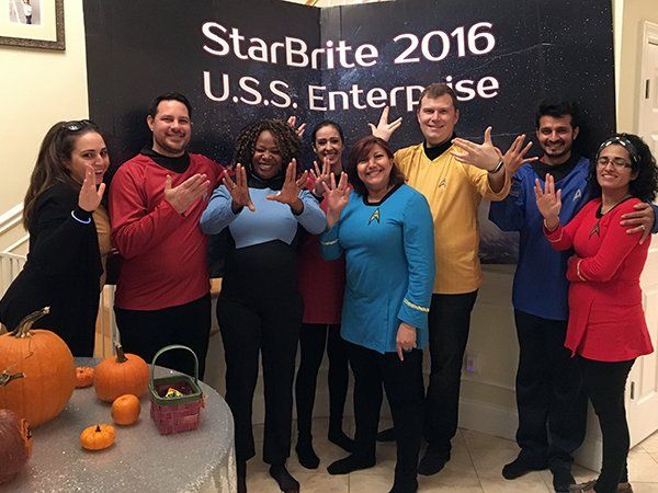 A group of people standing in front of a sign that says starbrite 2016 u.s.s. enterprise