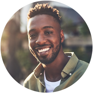A man in a green shirt is smiling in a circle