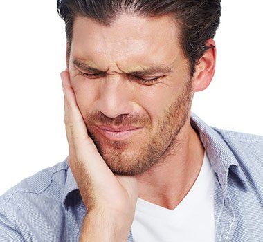 Man Holding Face in Pain