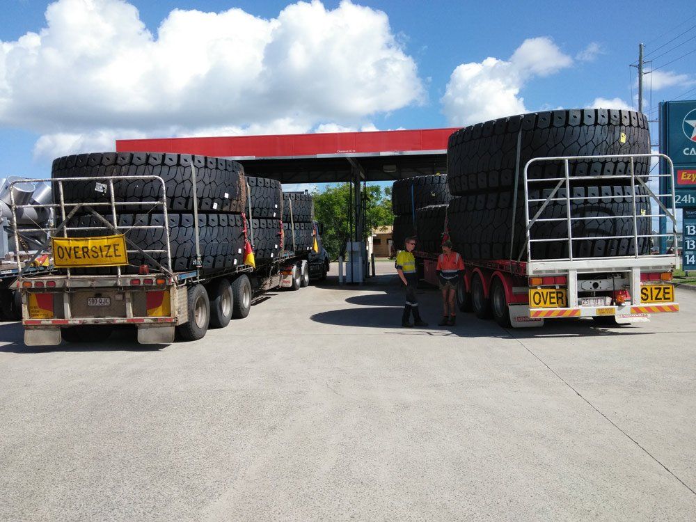 Worker With Transporting Truck — Edwards Transport, Cartage & Haulage in Gympie, QLD Worker With Transporting Truck — Edwards Transport, Cartage & Haulage in Gympie, QLD