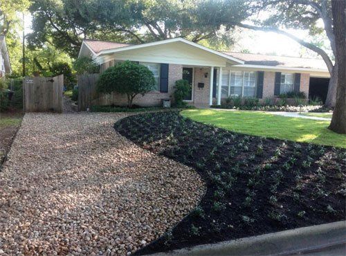 Mulched flower bed next to stone hardscape design