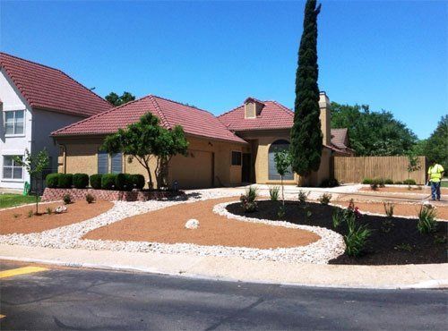 Front yard with stone walkway and mulched flower bed