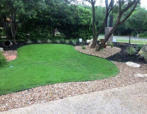 Green grass with stone border