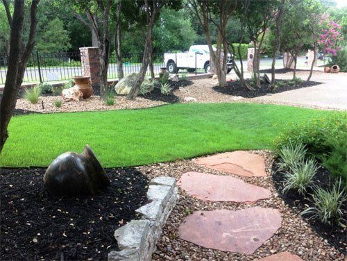 Green grass along side stone hardscape