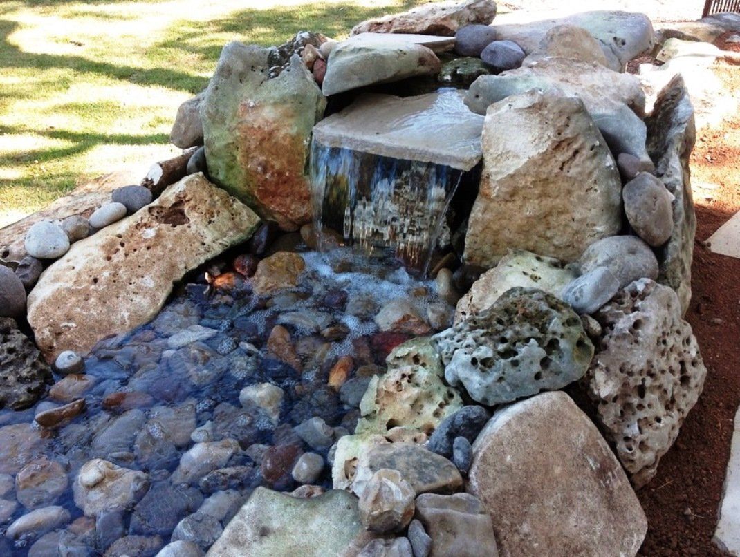 Stone and river rock waterfall decoration
