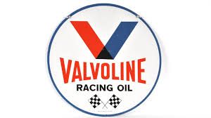 Valvoline Racing Oil sign: red and blue V, white background, checkered flags.
