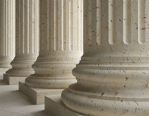 Stone columns in a row with fluted shafts and decorative bases.
