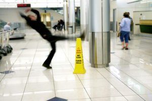Person slipping on wet floor, near a 