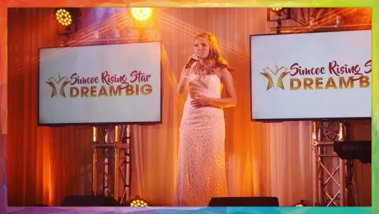 Woman speaking on stage with 
