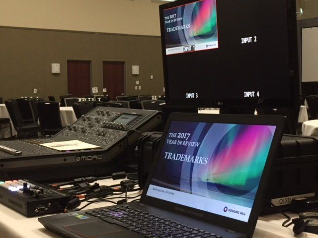 AV equipment on a table, including a laptop showing a 