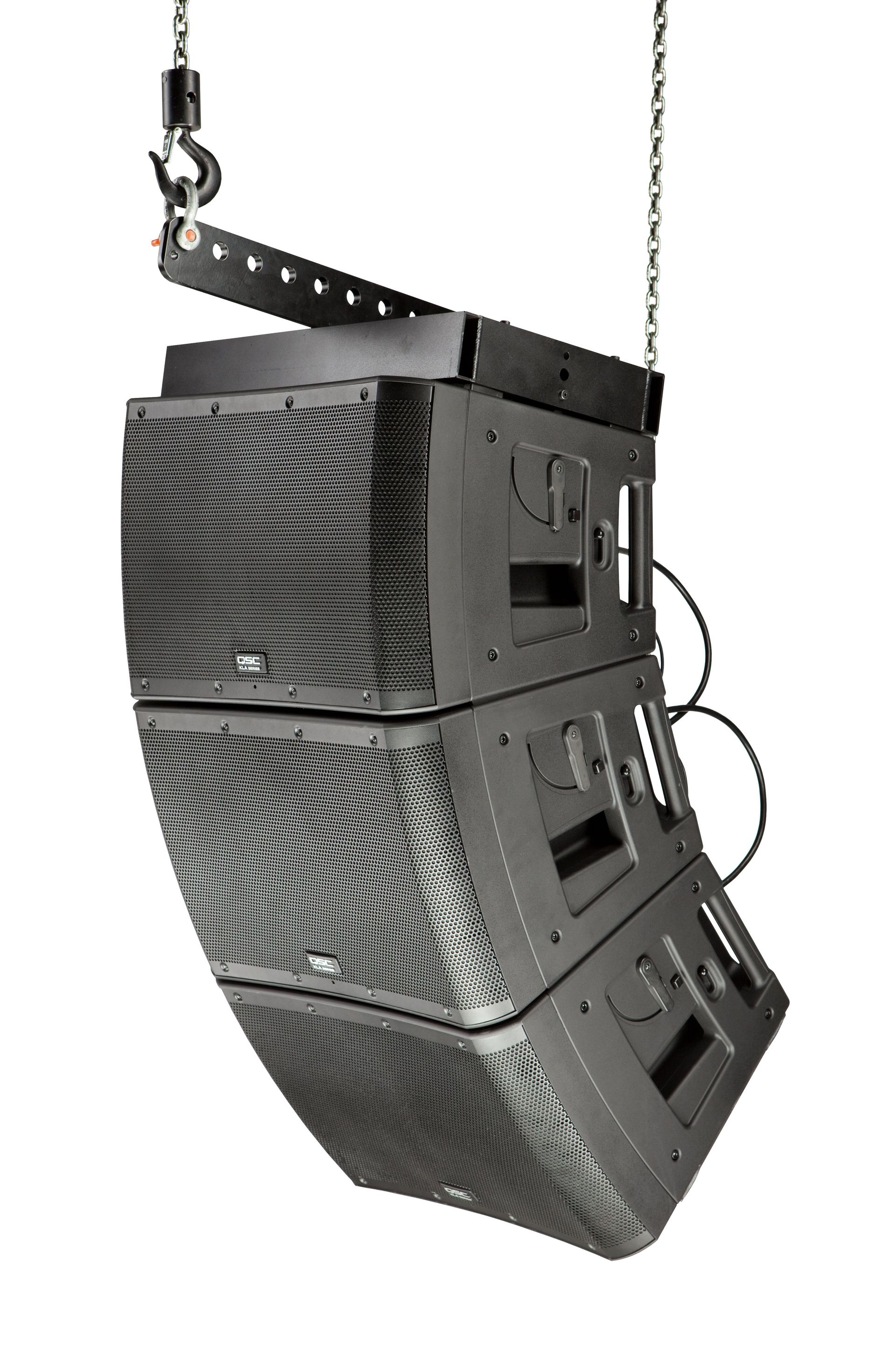 Hanging black line array speaker system, angled with visible grills, suspended from a chain.