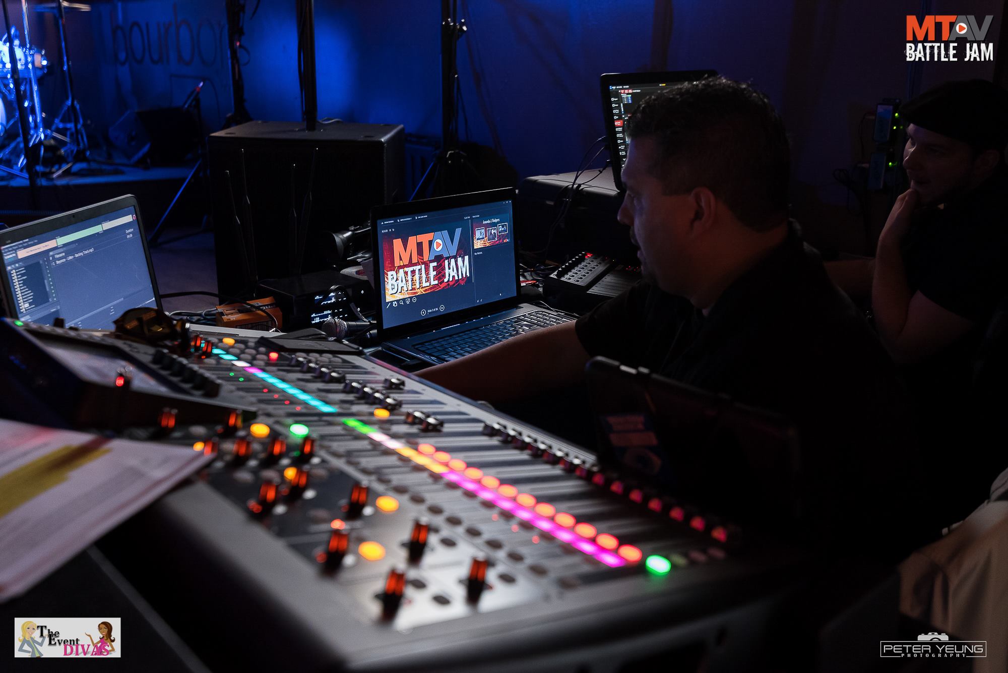 A sound engineer working at a soundboard, with laptops and monitors in a studio setting. The MTV Battle Jam logo is visible.