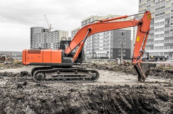 Utility Construction — Orange Tractor Digging Grounds For New Site in Florida, USA