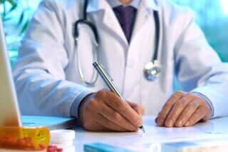 Doctor Writing His Record — McHenry, IL — George L. Stankevych, M.D. A gynecologist taking notes in McHenry, IL