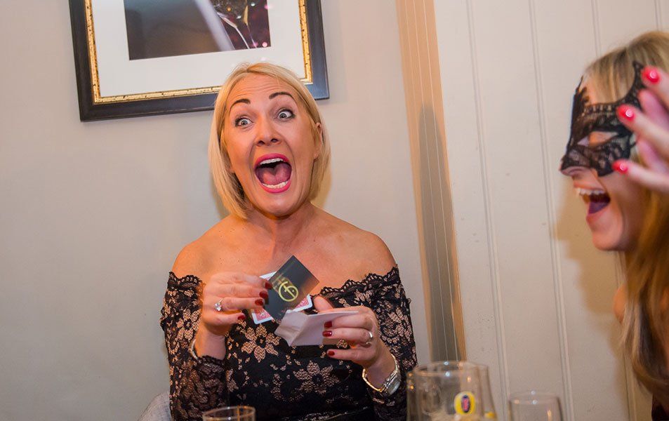 Guests reacting to a close-up magic performance in Bristol