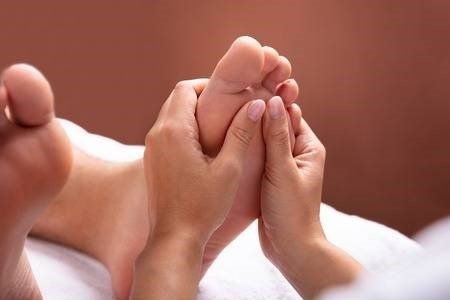 A person is getting a foot massage in a spa.