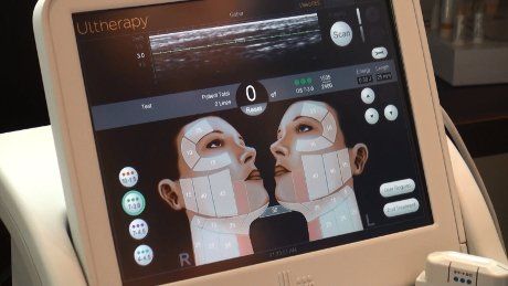 A woman is getting an ultrasound on her face.