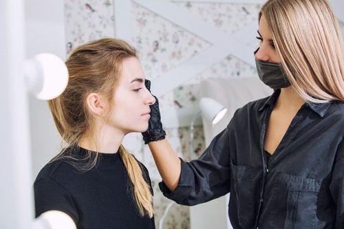Professional Makeup Artist Doing the Eyebrows of Client— Waterbury, CT — Dolce LLC Professional Makeup Artist Doing the Eyebrows of Client— Waterbury, CT — Dolce LLC