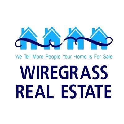 Logo for Wiregrass Real Estate: blue houses, scroll, text 