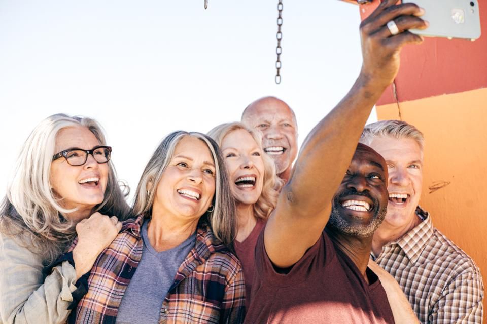 A group of older individuals taking a selfie