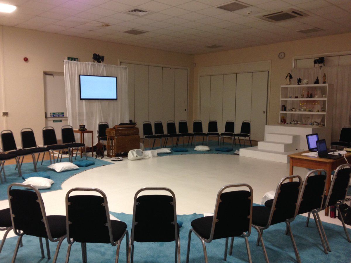 Plasma caption unit hangs above small stage with horseshoe seating arrangement. Plasma caption unit hangs above small stage with horseshoe seating arrangement.